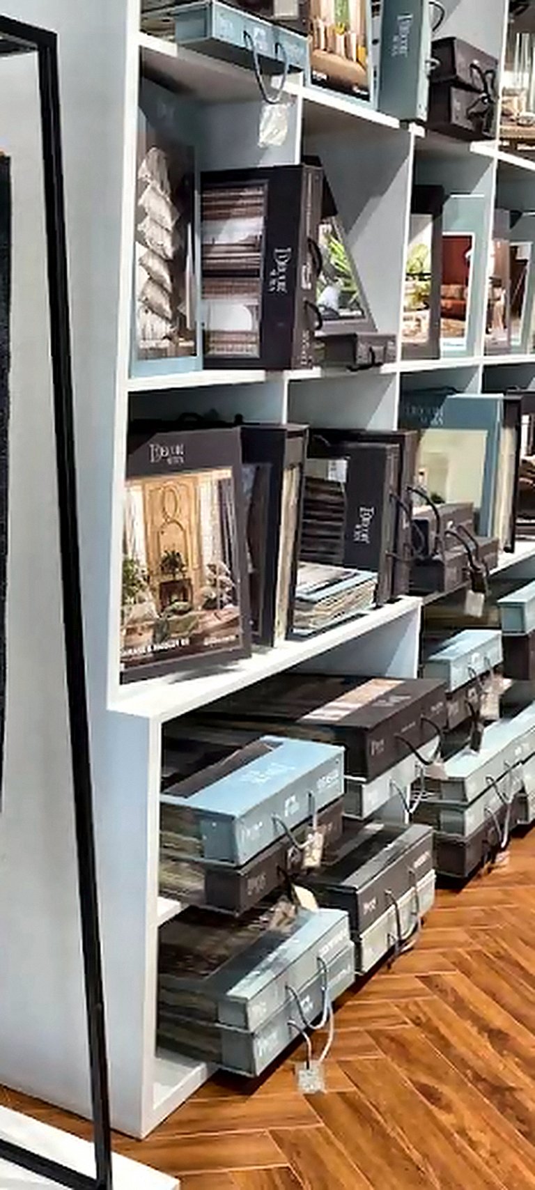Shelves of furnishing sample books and fabric catalogues at Opulence Decor