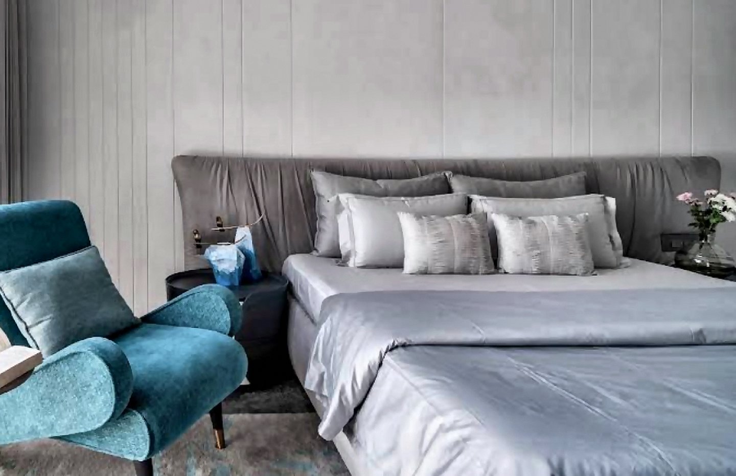 Neatly styled bed with layered linen in a Mumbai bedroom furnished by Opulence Decor