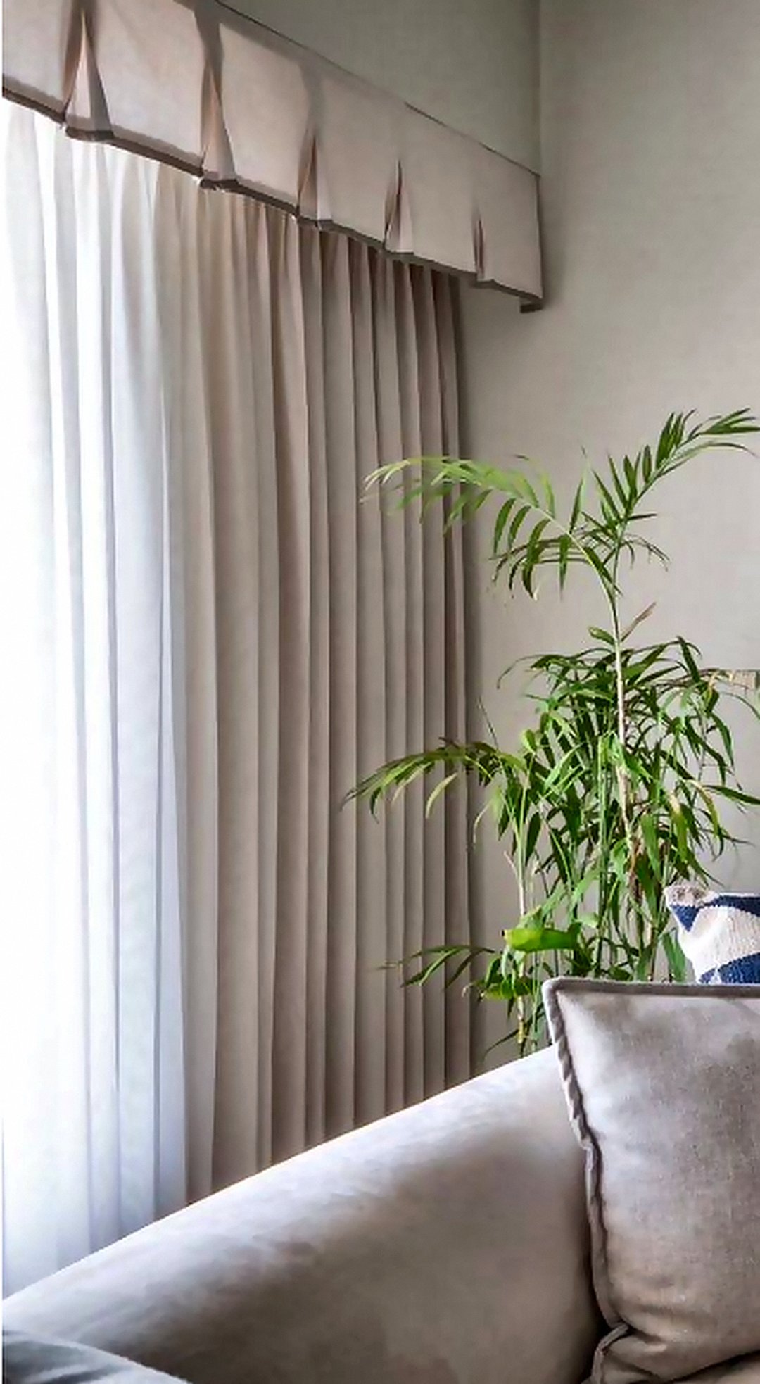 Pleated ivory curtains with a pelmet in a Goregaon living room, supplied and installed by Opulence Decor