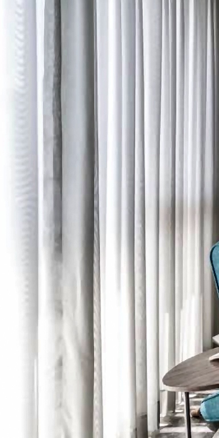 Sheer drapes and soft daylight in a Mumbai bedroom