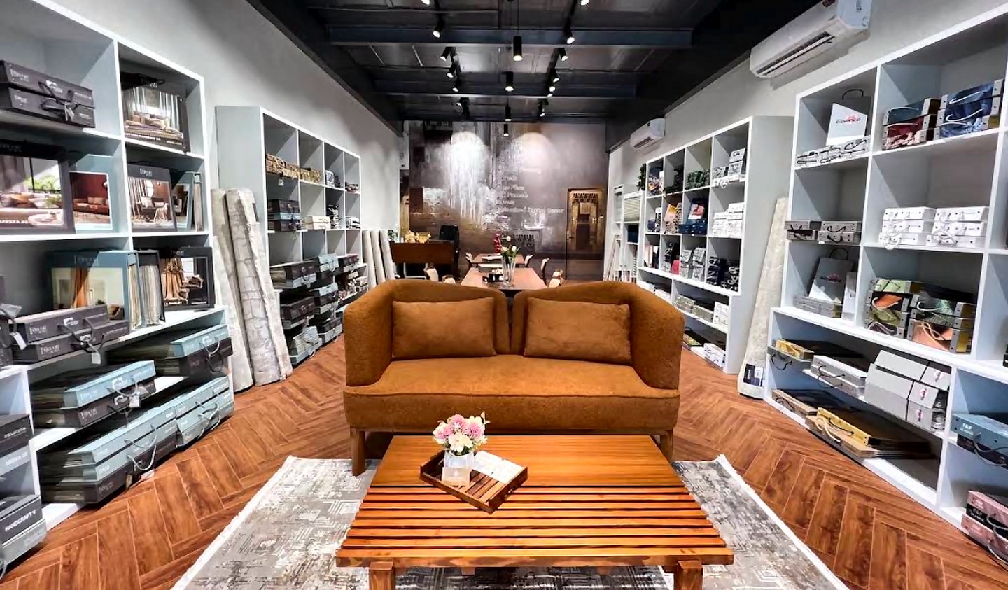 Inside the Opulence Decor showroom in Goregaon West with display shelving, upholstered seating and herringbone flooring